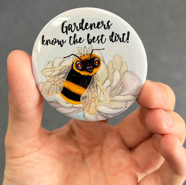 Funny gardener magnet held in hand to show 2.25-inch size and glossy finish