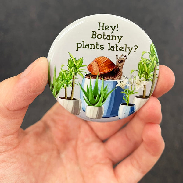 Funny plant lover magnet held in hand to show 2.25-inch size and glossy finish