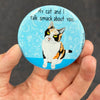 Funny calico cat magnet held in hand to show 2.25-inch size and glossy finish