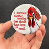 Funny office chicken magnet held in hand to show 2.25-inch size and glossy finish