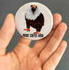 Funny coffee magnet held in hand to show 2.25-inch size and glossy finish