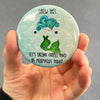 Funny mermaid magnet held in hand to show 2.25-inch size and glossy finish