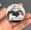 Funny coffee magnet held in hand to show 2.25-inch size and glossy finish