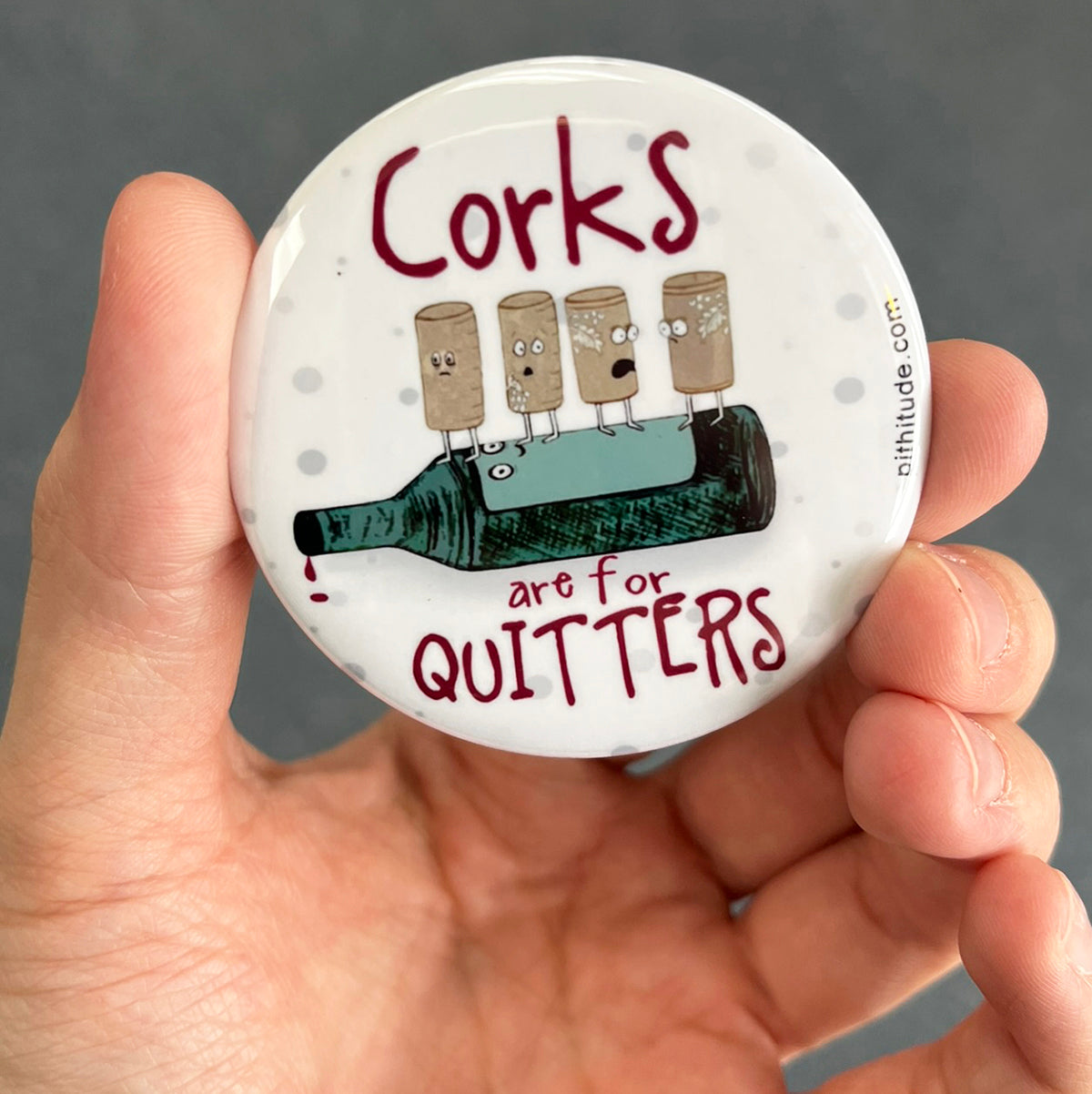 Funny wine magnet held in hand to show 2.25-inch size and glossy finish