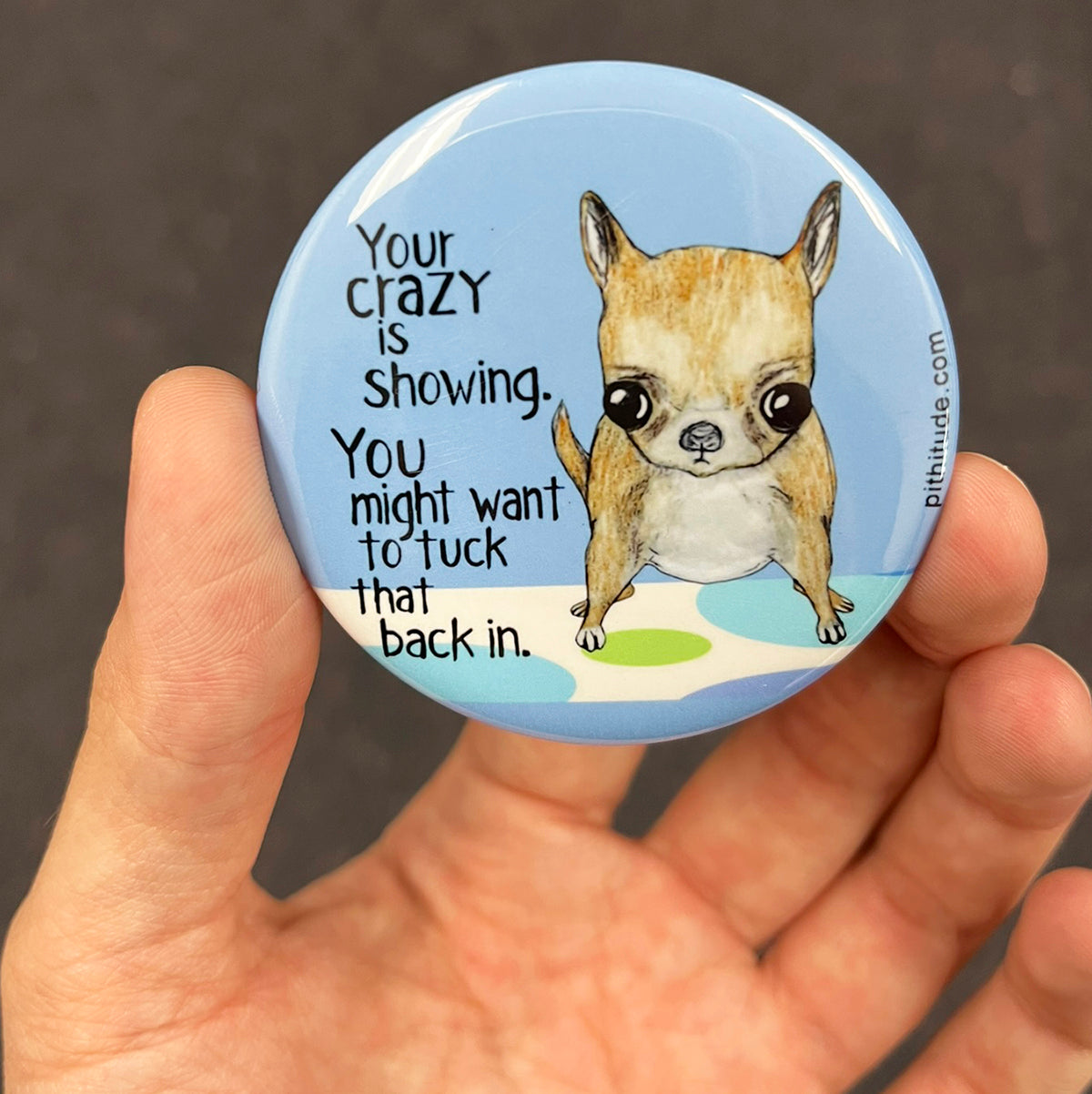 Funny Chihuahua magnet held in hand to show 2.25-inch size and glossy finish