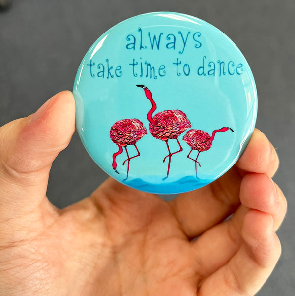 Inspirational flamingo magnet held in hand to show 2.25-inch size and glossy finish