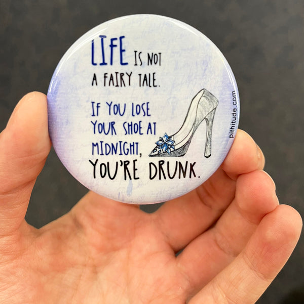Funny drinking magnet held in hand to show 2.25-inch size and glossy finish