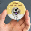 Funny Golden Retriever magnet held in hand to show 2.25-inch size and glossy finish