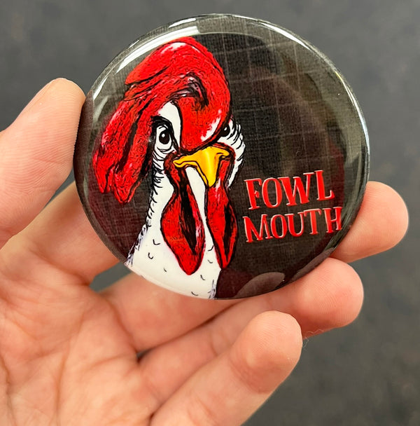 Funny chicken magnet held in hand to show 2.25-inch size and glossy finish