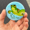 Happy sea turtle magnet held in hand to show 2.25-inch size and glossy finish