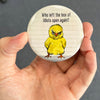 Funny chicken magnet held in hand to show 2.25-inch size and glossy finish