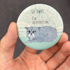 Funny introvert cat magnet held in hand to show 2.25-inch size and glossy finish