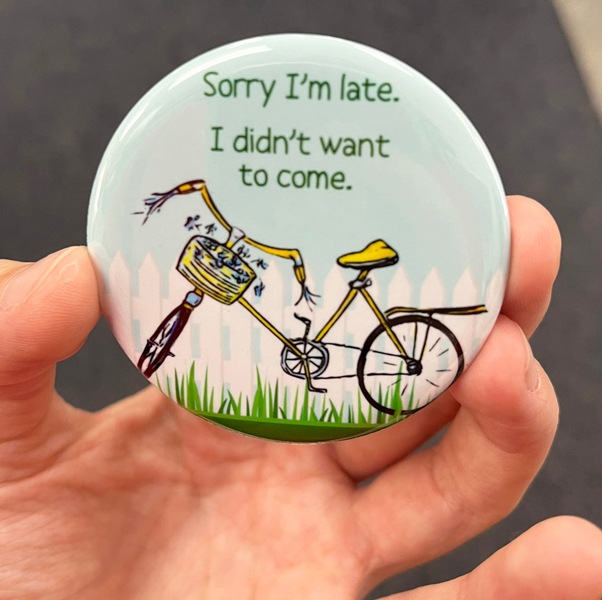 Funny introvert magnet held in hand to show 2.25-inch size and glossy finish