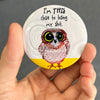 Funny owl magnet held in hand to show 2.25-inch size and glossy finish