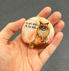 Funny Maine Coon magnet held in hand to show 2.25-inch size and glossy finish