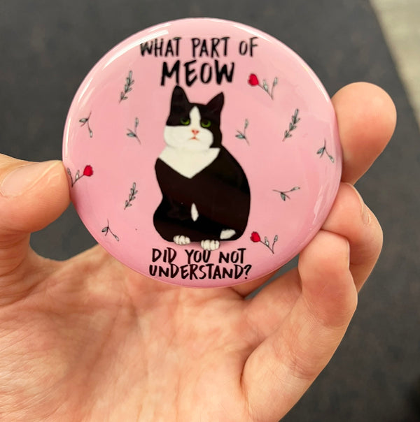 Funny tuxedo cat magnet held in hand to show 2.25-inch size and glossy finish