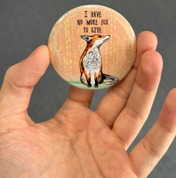 Funny fox magnet held in hand to show 2.25-inch size and glossy finish