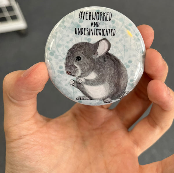 Funny work magnet held in hand to show 2.25-inch size and glossy finish