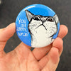 Funny cat lover magnet held in hand to show 2.25-inch size and glossy finish