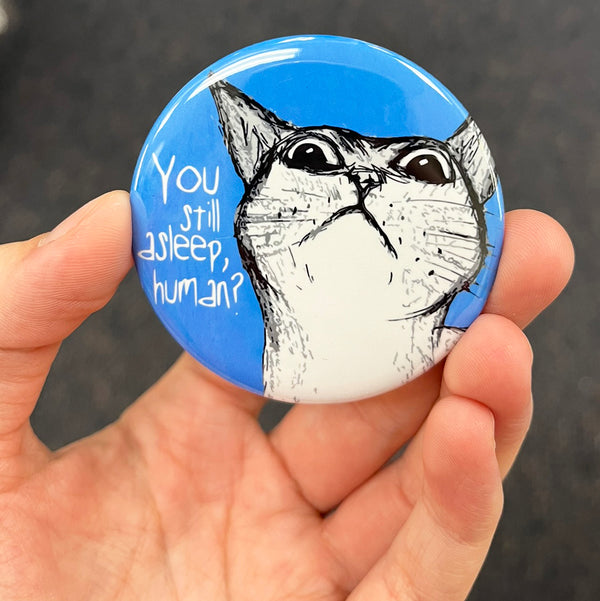 Funny cat lover magnet held in hand to show 2.25-inch size and glossy finish
