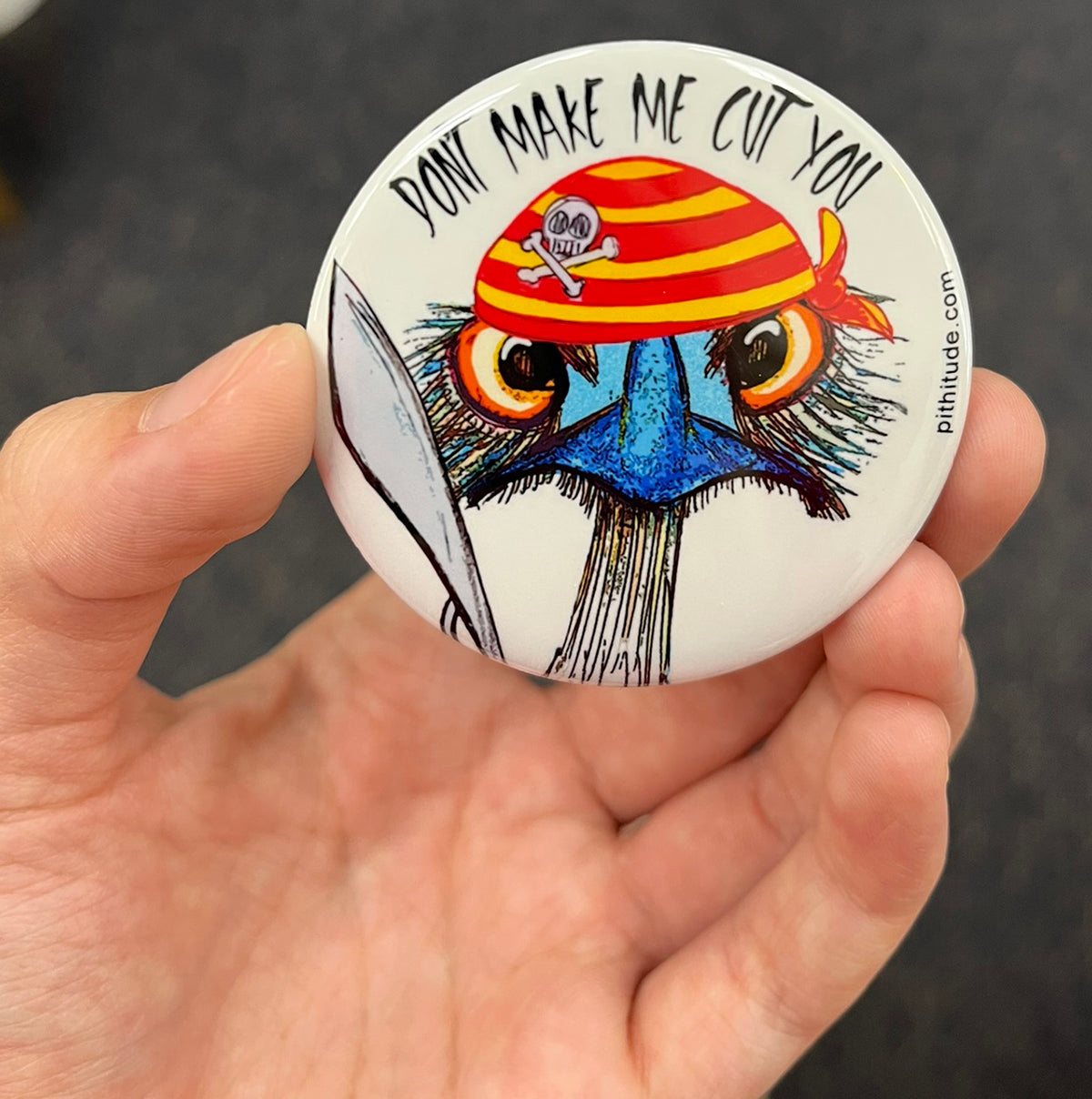 Funny pirate emu magnet held in hand to show 2.25-inch size and glossy finish
