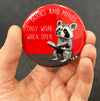 Book lover raccoon magnet held in hand to show 2.25-inch size and glossy finish