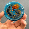 Whimsical mermaid magnet held in hand to show 2.25-inch size and glossy finish