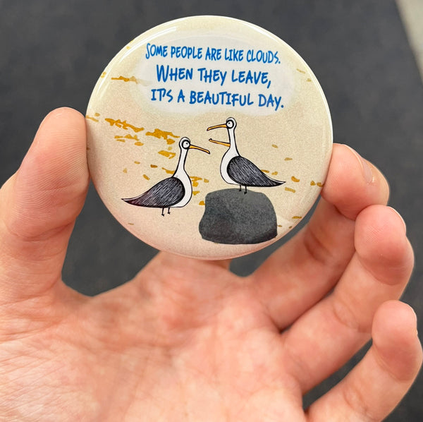 Funny seagull magnet held in hand to show 2.25-inch size and glossy finish