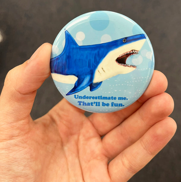 Funny shark magnet held in hand to show 2.25-inch size and glossy finish
