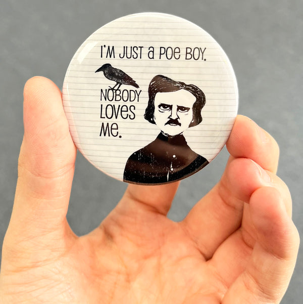 Funny Edgar Allan Poe magnet held in hand to show 2.25-inch size and glossy finish