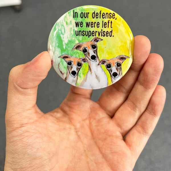 Funny Greyhound magnet held in hand to show 2.25-inch size and glossy finish
