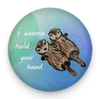 Romantic sea otter magnet held between fingers to show 2.25-inch size